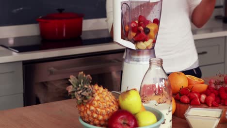 happy woman making smoothie