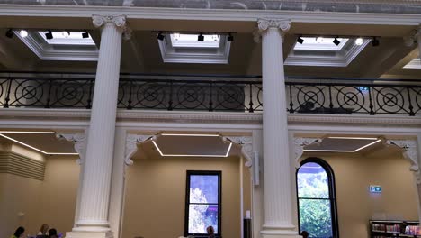 people studying in a grand library setting