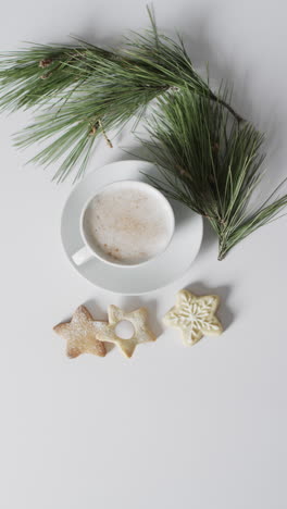 vertical video of mug of christmas chocolate with cookies and copy space on white background