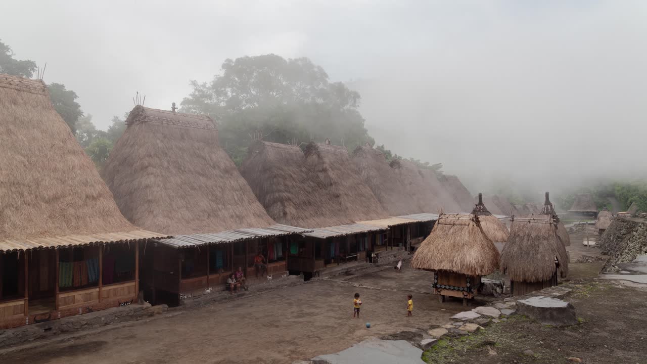 Traditional Bena Village with Thatched Roof Houses in Misty Flores, Indonesia