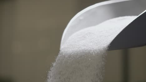 Slow-Motion-Shot-Of-Person-Moving-Big-Pot-And-Sugar-Falling-Down