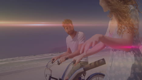 man and woman cycling on beach at sunset, illustrating health featuring floating heart icon + graph