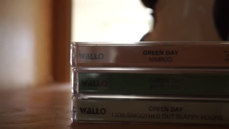 wide pan of vintage greenday tapes - cassettes on a shelf