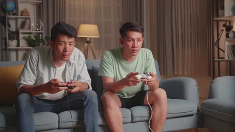 two men playing video games at home