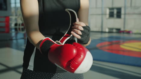 woman putting on boxing gloves