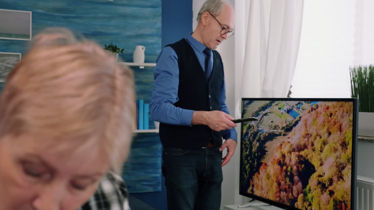 mujer vieja madura enfocada y elegante trabajando remotamente desde casa en una computadora portátil