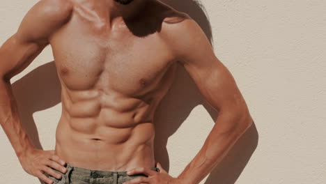 man with toned abs posing outdoors