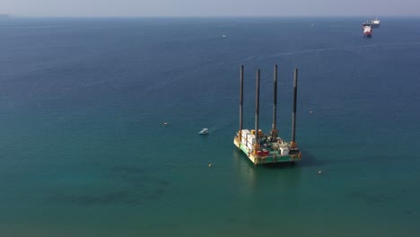 Offshore-Area-Jackup-rig-or-Self-elevating-Platform-SEP-For-Marine-Oil-Exploration-in-Eilat-city,-Israel---Aerial-Orbiting-Around