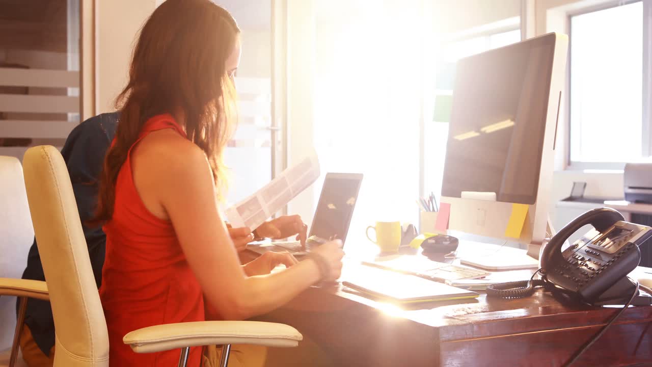 Male and female graphic designers using graphics tablet