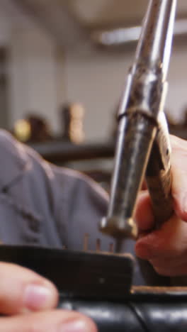 shoemaker hammering on a shoe