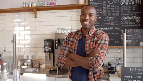 business owner crosses arms at the counter of coffee shop