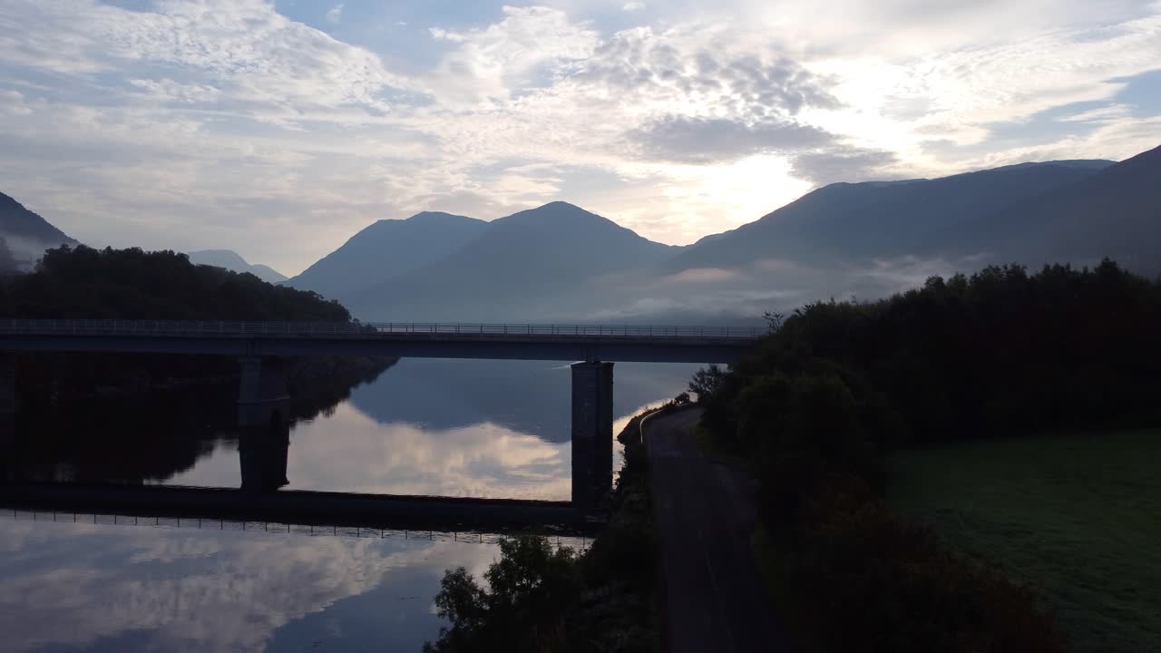 Sunrise over a Scottish Loch with Bridge