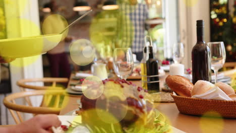 animation of spots of light over table set for christmas dinner at home