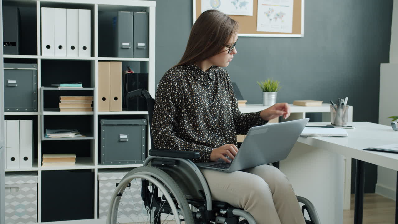 Woman in Wheelchair Working in Modern Office