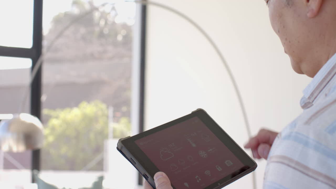 Holding tablet, person checking weather app while on vacation indoors