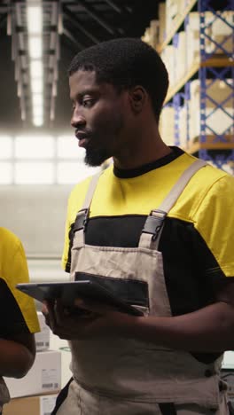 vertical video black e-commerce team vlogging in a warehouse shipping area