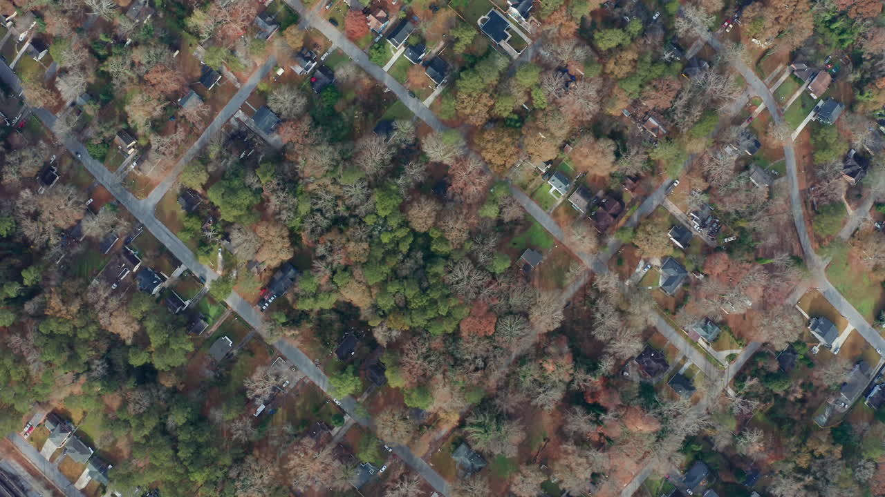 An overhead aerial tracking to the right across a scenic and historic Westside Atlanta, Georgia neighborhood, where a mix of working class people mix with new development and businesses.