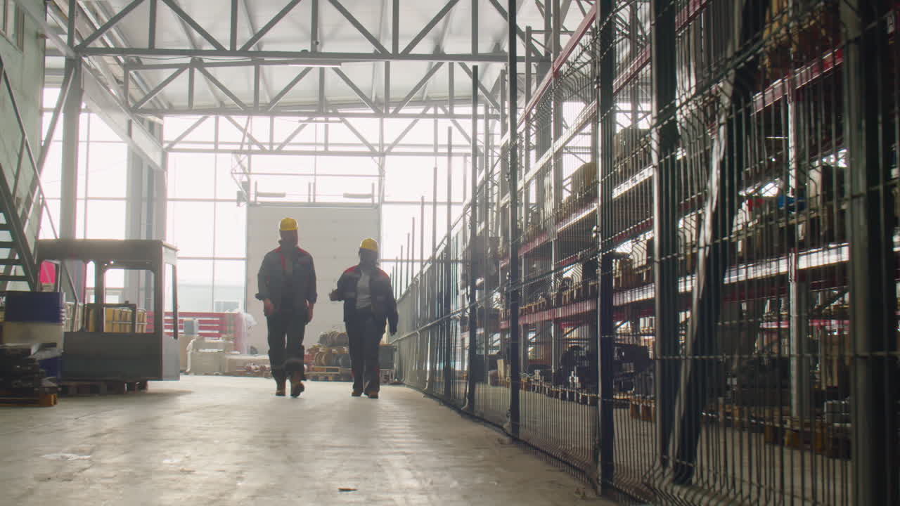 Factory Workers Walking in Warehouse and Talking