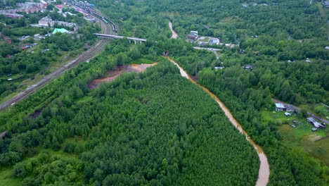 aerial view of industrial pollution affecting a river in a rural area