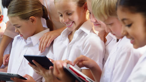 teacher teaching kids on digital tablet