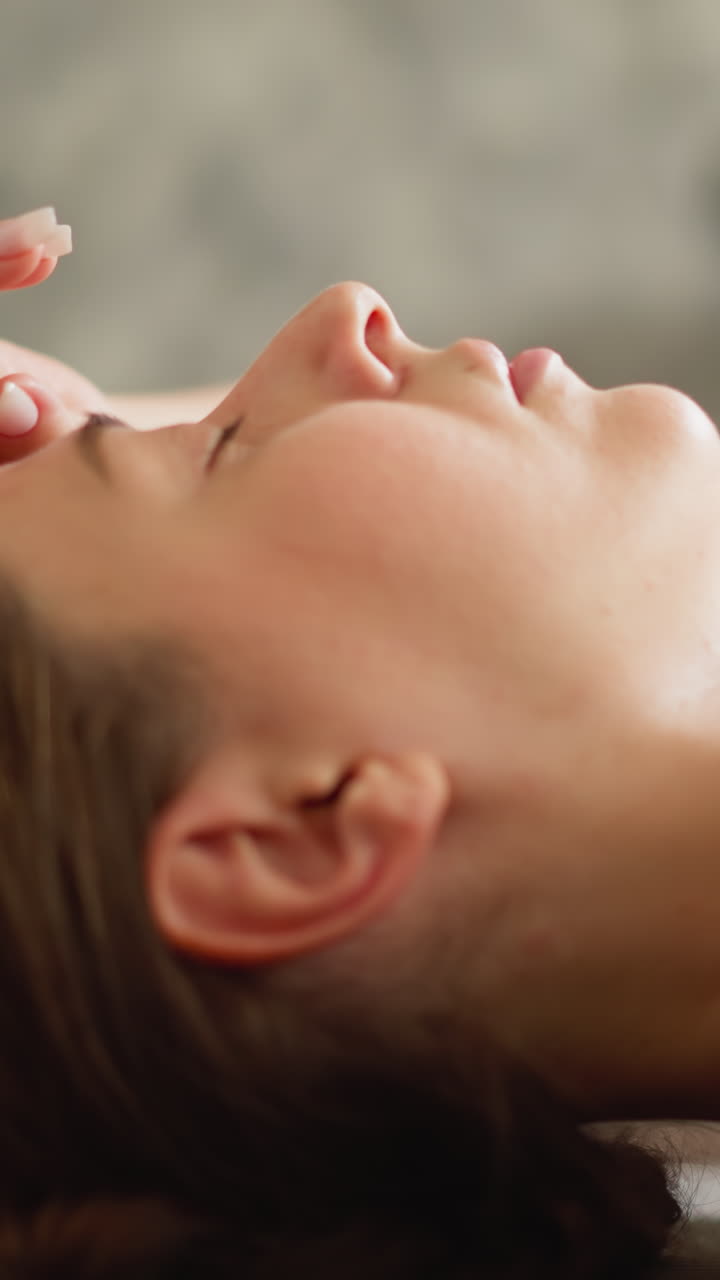 Exhausted woman reclines relaxing on ground closeup. Weary lady rests reclining on mat putting hand on head indoors. Athlete pauses after physical strain