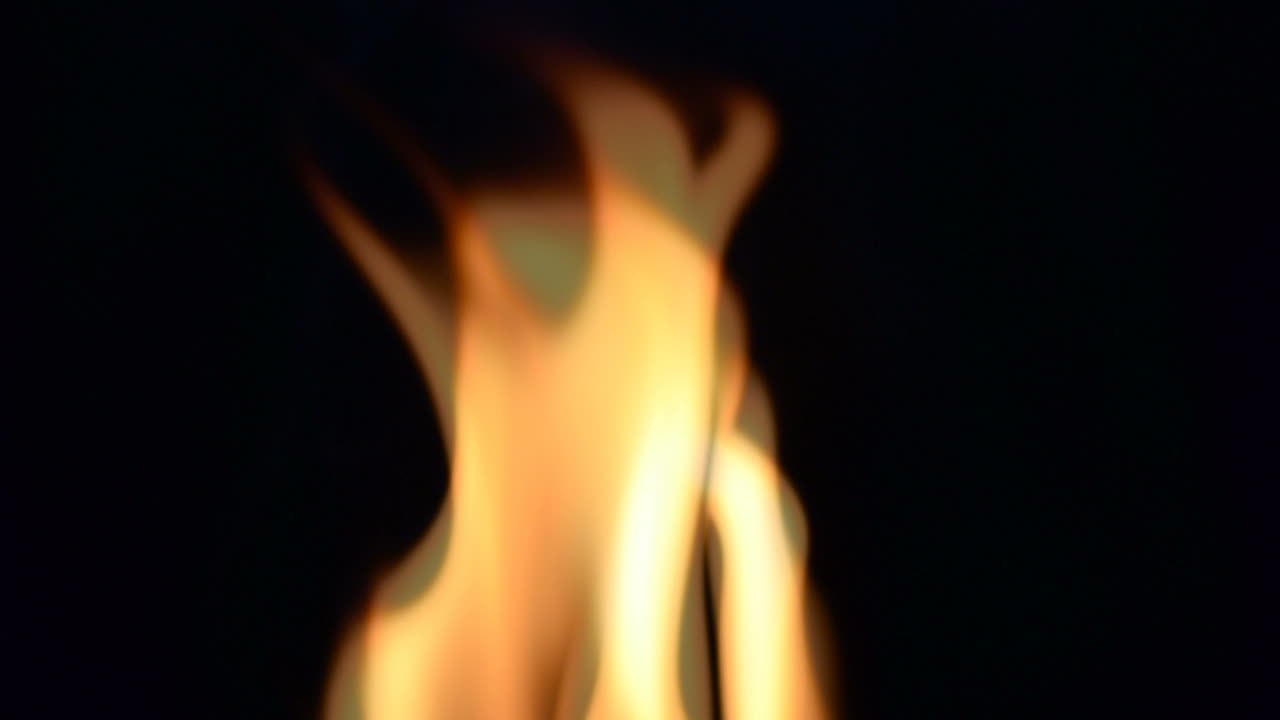 Slow Motion. Fire on a black background. Slow Motion. Tongues of flame