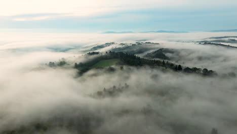 clouds and fog over the mountain hills, trees and forest in sunrise in turcany, italy