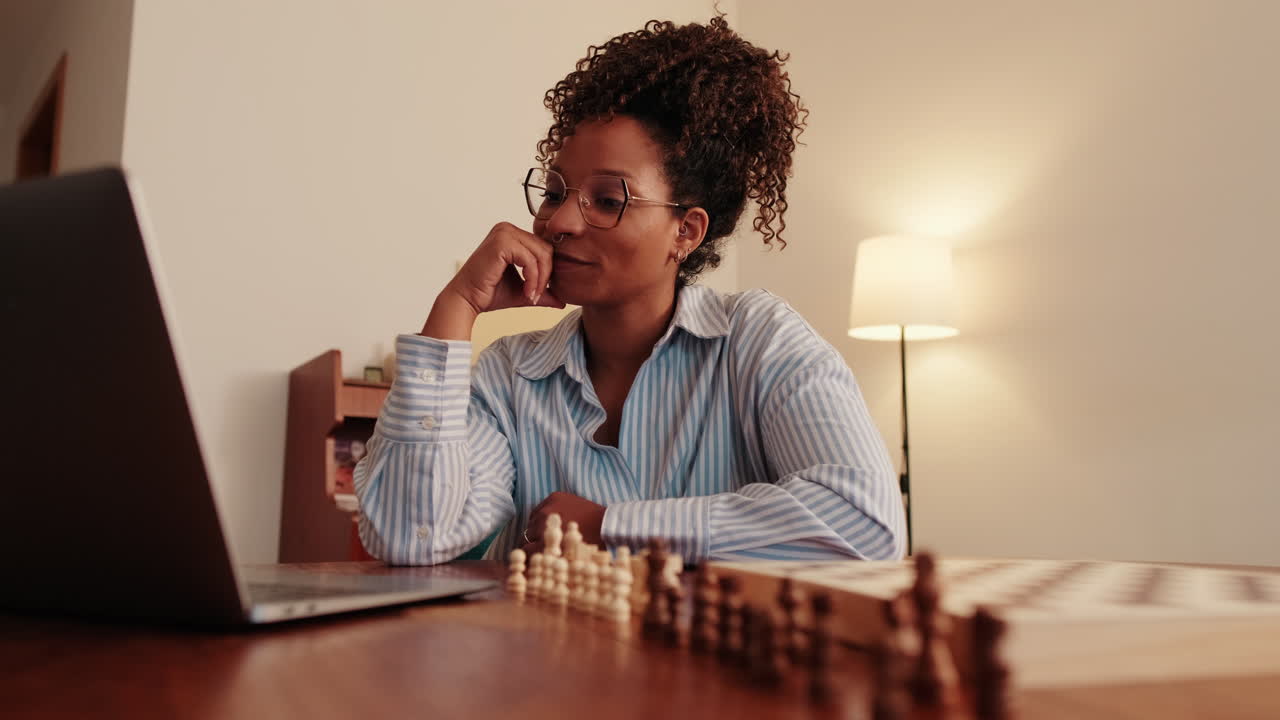 Woman Playing Online Chess at Home