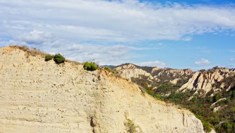 drone ascending push shot over rock sand formation cliff edge