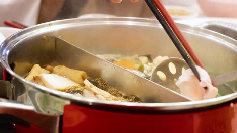 preparing hotpot with fresh ingredients in thailand