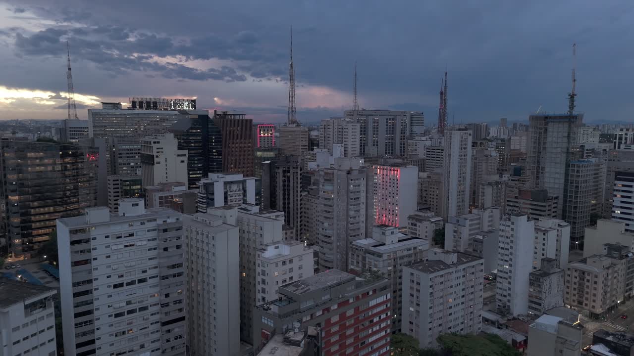 High-rise Commercial Buildings With Antenna Towers At Dusk In Sao Paulo, Brazil. - aerial shot