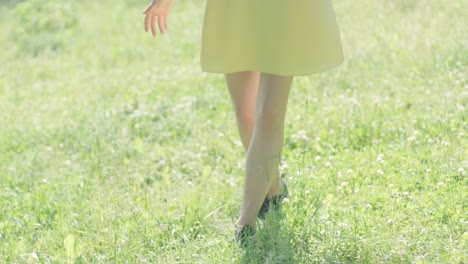 woman in yellow dress dancing gracefully in summer park