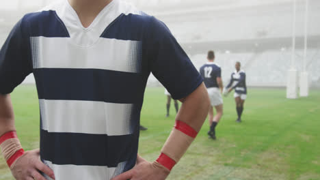 animación de cuadrados coloridos sobre jugadores de rugby masculinos en el estadio