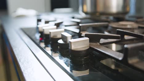hand ignites flame of stovetop. slow-motion and close up