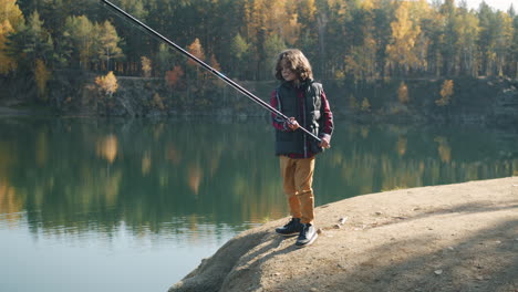 boy fishing in autumn quarry