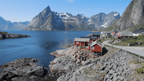 Shot-over-pretty-red-houses-of-Hamnoy-village-with-mountains-in-the-landscape