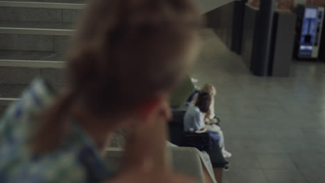 boy standing stairway inspecting school hall close up. children playing tablet.