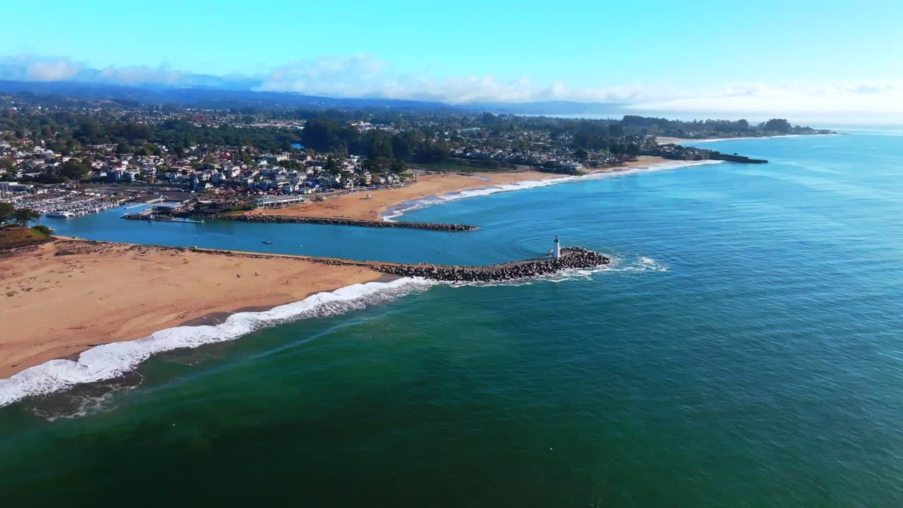 SeaBright Blacks Beach Walton Lighthouse Monterey Bay Santa Cruz California aerial drone scenic landscape deep blue surf waves sand Pacific Ocean Pleasure Point morning blue sky mist fog forward down
