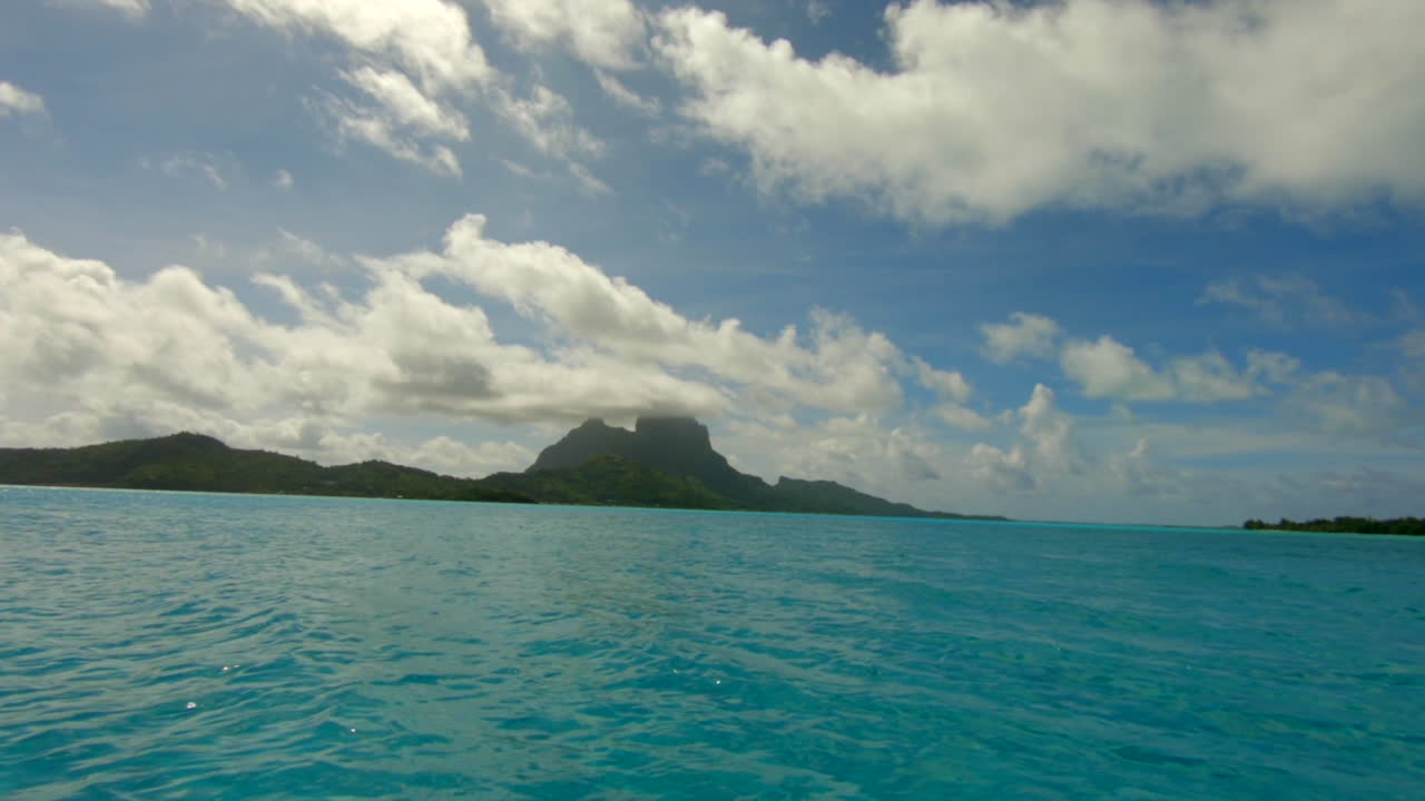 Sailing with a dingi over the ocean in front of Bora Bora in French Polynesia