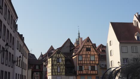 scenic static shot of beautiful medieval architecture with a blue sky in colmar, france