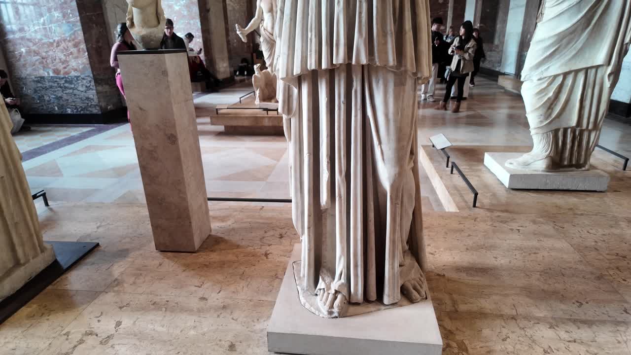 Closeup legs of white marble sculpture. Lower half of ancient roman or greek statue.