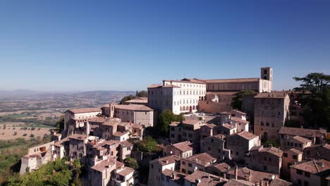 aerial view of medieval town todi on top of a green hill, italy, crane shot