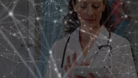 Animation-of-network-of-connections-over-caucasian-female-doctor-using-tablet