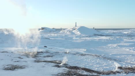 Stunning-Reykjanes-Lighthouse-in-snow-covered-landscape-with-bright-sunlight