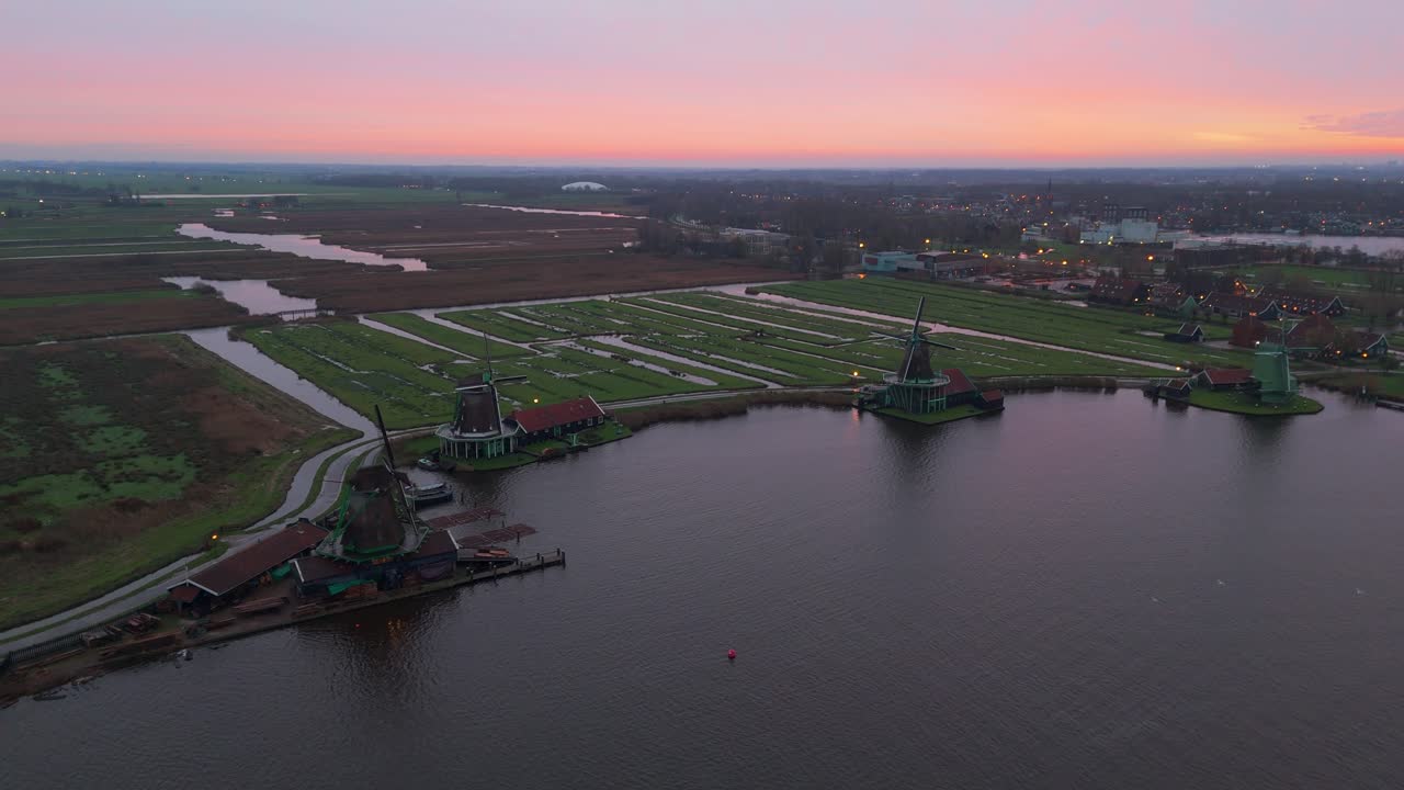 Dronevideo of the Windmills of zaanse schans (close to Amsterdam) in the early dawn lights.