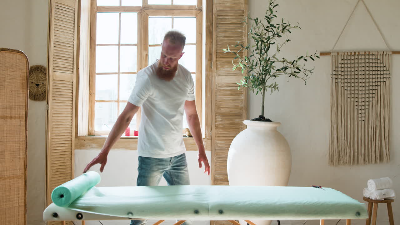 Masseur preparing the room for the next client