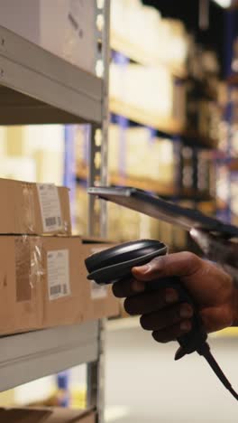 vertical video african american e-commerce employee scanning awb tracking numbers