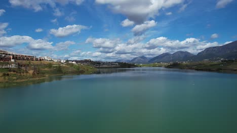 serene waters of farka lake reflecting the construction of luxurious housing complexes on the outskirts of tirana's capital