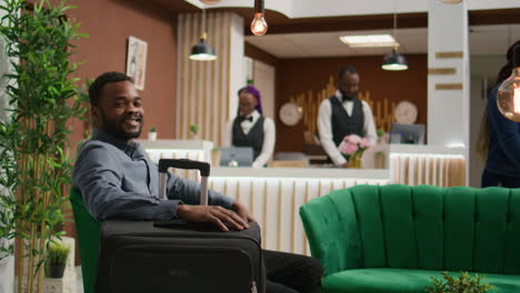 hotel guest waits in lobby for check in