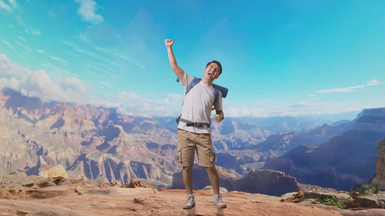 Full Body Of Asian Male Hiker With Mountaineering Backpack Screaming Goal Celebrating The Success While Traveling At The Top Of Mountain